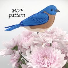 a blue bird sitting on top of pink flowers with the words pddf pattern above it