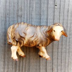 a small statue of a sheep on a wall