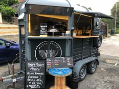 an outdoor food truck is parked on the side of the road