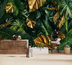 a tropical wallpaper with gold leaves and other greenery on the walls in a living room