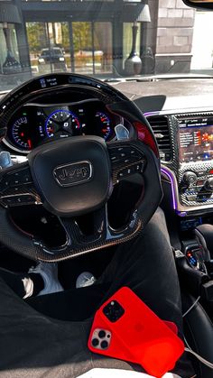 the interior of a car with steering wheel and dashboard