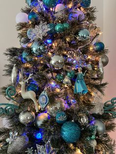 a decorated christmas tree with blue and silver ornaments