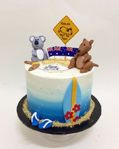 there is a cake that has two bears on it and a sign in the background