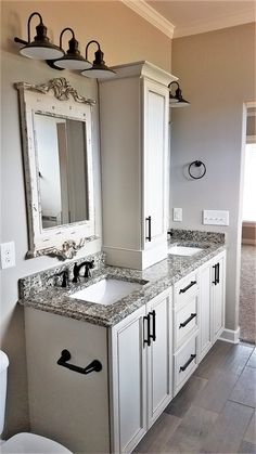 a bathroom with two sinks and mirrors in it