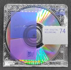 a cd that is sitting on top of a plastic case with the label happy colors for digital recording