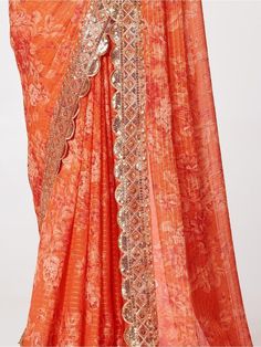 Be an angel and create and establish a smashing influence on every person by wearing this orange organza wedding wear saree. The designer, floral printed with sequin embroidery work and zari work appears to be chic and best for any occasion. This beautiful orange organza saree comes with a similar color blouse embellished with the same design as the saree. This cute orange wedding wear saree is 5.75 meters long and comes with fully unstitched 0.80 meters blouse material. Update your clothing sty Orange Anarkali Organza Sets, Orange Lehenga With Sheer Dupatta, Anarkali Pre-draped Saree With Printed Border For Festivals, Wedding Semi-stitched Pre-draped Saree With Printed Motifs, Festive Orange Organza Lehenga, Wedding Pre-draped Semi-stitched Saree With Printed Motifs, Festive Orange Pre-draped Saree, Bollywood Style Fitted Saree With Printed Motifs, Fitted Saree With Printed Motifs For Festive Occasion