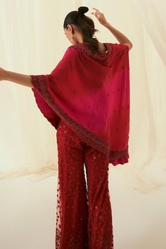 Rani and red one side cape with hem work of sequins and cutdana. Paired with red embroidered sharara. - Aza Fashions Silk Dupatta With Cape Sleeves For Festivals, Red Silk Palazzo Set With Mirror Work, Red Traditional Drape Palazzo Set For Celebration, Red Palazzo Set With Sheer Dupatta For Party, Red Palazzo Set For Celebration With Traditional Drape, Red Palazzo Set For Celebration, Traditional Sharara With Dabka Work And Cape Sleeves, Festive Red Dress With Cape Sleeves, Red Palazzo Set With Mirror Work For Party