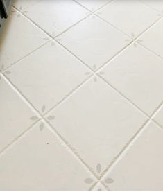 a tile floor with white tiles on it