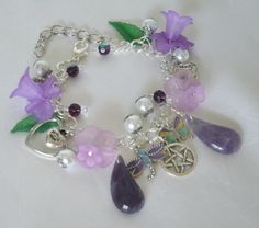 a bracelet with charms and flowers on it