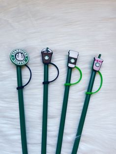 four green pens with starbucks logos on them are lined up in a row against a white background