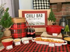 a table topped with lots of food next to a red and black checkered table cloth