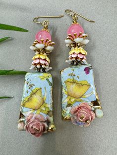 Handmade ceramic  floral charms by Lina. Charms are topped with white enamel bead caps, pink and yellow ceramic bead caps, enameled floral with rhinestones bead caps, and Cherry Quartz. Bohemian Flower Earrings With Colorful Beads, Handmade Pink Bohemian Flower Earrings, Handmade Bohemian Pink Flower Earrings, Artistic Pink Flower Jewelry, Bohemian Flower-shaped Earrings, Bohemian Flower-shaped Earrings With Colorful Beads, Cherry Quartz, Ceramic Earrings, Enamel Beads