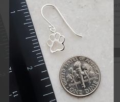 Pet Lovers Rejoice! These adorable sterling silver dog paw print in open design are lightweight and easy to wear. Perfect gift to any dog or cat parents. .925 Sterling silver ear wires. Made in the USA. See image for dimensions. Adjustable Silver Jewelry With Paw Print, Adjustable Sterling Silver Paw Print Jewelry, Adjustable Sterling Silver Jewelry With Paw Print, Sterling Silver Jewelry With Paw Print, Paw Print Earrings, Cat Parents, Silver Dog, Cat Parenting, Dog Paw Print