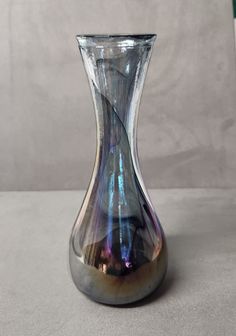 a glass vase sitting on top of a table