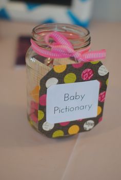 a jar with a label that says baby dictionary on it sitting on a table next to other items