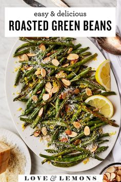 roasted green beans with lemons and parmesan cheese on top, in a white plate