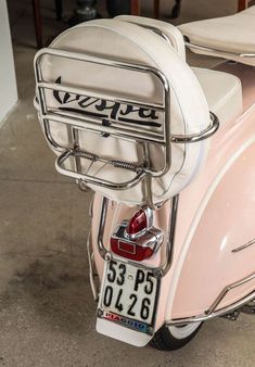 a pink scooter parked in a garage