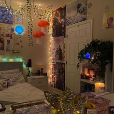 a bedroom decorated with lights, candles and pictures on the wall next to a bed