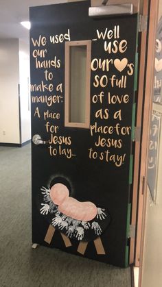 a door decorated to look like a baby's crib with words written on it