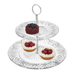 three tiered tray with cupcakes and berries on top