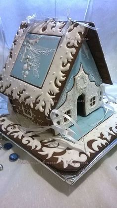 a cake shaped like a house on top of a table