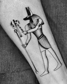 an egyptian tattoo on the arm