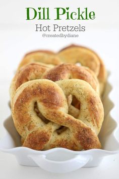 some pretzels are in a white dish on a table with the words dill pickle hot pretzels