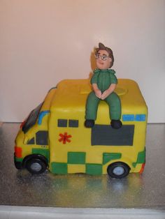 a cake made to look like a bus with a man sitting on top