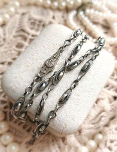 "Beautiful Antique French Late XIX-Century to 1910s Silver (Marked) Ornate Chain Necklace with Diamond Paste Closure, Gift for Woman  Size -  Total length - approx. 43cm / 16,92\" Chain is in a perfect antique condition, very high quality, thick and heavy, beautifully detailed with ornate segments, made of a silver and diamond paste stones in an elegant clasp. So sophisticated, unique piece! ✨  Perfect as a gift for antique and vintage loving woman! 🧡 Great also as a vintage wedding jewelry!  Found somewhere in France :)  __ Maybe you are looking for something specific from France? 🕵️♀️😗 If you like, you can contact me and ask! With a pleasure I will look for it and check if I can find it for you! ❤️" Luxury Antique Jewelry With Sterling Silver Clasp, Luxury Antique Silver Jewelry As Gift, Luxury Antique Jewelry With Box Chain, Luxury Sterling Silver Jewelry With French Hook, Luxury Antique Jewelry With Adjustable Chain, Luxury Handmade Antique Silver Necklace, Vintage Oval Link Necklace With Vintage Charm, Victorian White Gold Necklace For Anniversary, Victorian Style White Gold Necklace For Anniversary