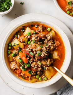 two bowls of soup with meat and vegetables