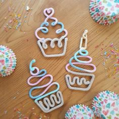 some cupcakes are sitting on a table with sprinkles