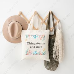 "Introducing our Chingaderas and Stuff Tote Bag - the perfect reusable accessory for all occasions! This cute Latina bag is an ideal birthday gift for mom, sister, or friend, and a delightful Christmas present. Made from durable materials, it's a versatile choice for carrying your essentials. Embrace your Mexican and Spanish heritage with style. Shop now and make a chic statement! This 100% cotton bag comes in one size - 15\" x 16\"- perfect for everyday wear. While the canvas material will show off your designs in great colors, it's durable and will last for years. The bag features 20\" handles (made from the same canvas), making it easy to carry even with a week's worth of shopping." Reusable Rectangular Canvas Bag For Gifts, Rectangular Reusable Canvas Bag For Gifts, Bohemian Canvas Tote Bag As Gift, Rectangular Reusable Canvas Gift Bag, Embroidered Canvas Shoulder Bag For Shopping, Eco-friendly Reusable Shoulder Bag For Gifts, Bohemian Embroidered Canvas Tote Bag, Mexican Mercado Bags, Mexican Handbags Tote Bags