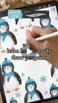 someone is drawing on an ipad screen with penguins and snowflakes in the background