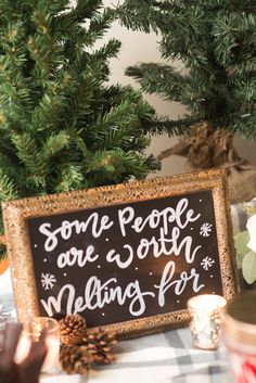 there is a sign that says some people are worth melting for christmas tree decorations on the table