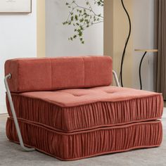 an orange couch sitting on top of a carpeted floor