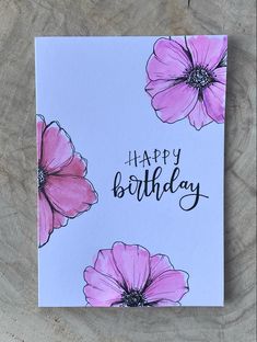 a happy birthday card with pink flowers and the words happy birthday written in black ink