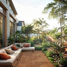 an outdoor living area with couches and potted plants on the side of the house