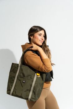 MEET REVEILLE. "Reveille" - the signal to wake up in the morning across military bases. The perfect name for our new line. Reveille is a collection of bags made to last and meet your needs on the go no matter where you go. Not only does your new shoulder companion help you achieve your dreams each day, it also gives back to women with hustle and grit starting their own dream just like R. Riveter. So go on, girl, and do what only you can do.Rise and Shine!☀️ Margot - This is your tote. It’s the perfect one arm, over-the-shoulder commuter bag that you can transition straight to poolside when the time comes. Margot's interior is open and generous with space, and the exterior slip pocket keeps your essentials right where you need them. Base Width 12" x Base Depth 5.75" x Height 13.75" x Openin Military Bases, Wake Up In The Morning, Limited Edition Bag, Achieve Your Dreams, Pool Bags, Commuter Bag, Military Base, Women’s Rights, Nylon Tote