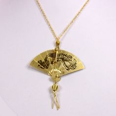 "1970s Large folding fan necklace 14kt gold plated with your choice of chain size 16\", 18\" or 20\"at no additional charge. The fan measures approximately 2\" wide by 2 1/4\" high with a scene of etched cranes taking flight and landing. In the Chinese culture fans were worn made of different materials to represent wealth and status. The  flying cranes in Japanese culture are symbols of good fortune and longevity. This particular style of cross has a brooch type pin on back to secure it if you w Ancient Chinese Accessories, Chinese Coin Necklace, Vintage Chinese Jewelry, Chinese Necklace, Fan Necklace, Japanese Jewelry, Japanese Fan, Folding Fan, Old Jewelry