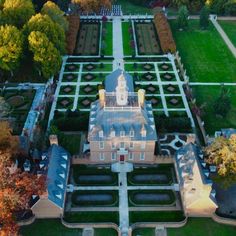 an aerial view of a large building surrounded by trees