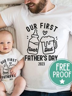 a father and his baby wearing matching t - shirts with the text our first dad's day