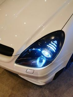 the headlight of a white sports car