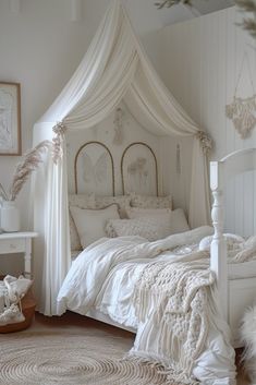 a white bed sitting in a bedroom next to a rug on the floor and pillows