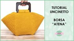 a crocheted yellow purse is shown with the words,'borsa atena '