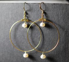 1 1/2 inch diameter gold plated hoops have this cut 7mm pearl dangling in the center and bottom.   All wires and components are gold plated.  Great quality pearl.   Chic and stylish,  also available in clip on style. Gold Metal Hoop Earrings With Pearl Charm, Gold Hoop Pearl Earrings Nickel Free, Gold Hoop Earrings With Pearl Drop In Brass, Gold Brass Hoop Earrings With Pearl Drop, Hammered Jewelry, Pearl Earrings Wedding, Dangle Hoop Earrings, Pearl And Diamond Earrings, Pearl Hoop Earrings