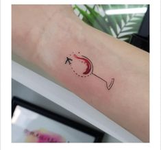 a small tattoo on the arm of a woman