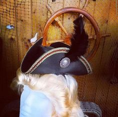 Arrrr! This mini leather tricorn fascinator will make you feel like you are on the high seas! This mini black leather tricorn style hat has gold/red/black laced edging, silver and gold concho , an ostrich feather, and black silk lining on inside. These hats are made to order and are one size fits all. Use attached plastic head band or tie a ribbon to hold on your head. Choose color of feather. Perfect to complete your Pirate, Steampunk or Victorian style costume! Steampunk Pirate, How To Tie Ribbon, Steampunk Hat, Hat Base, Mini Top Hat, Leather Hat, Tea Party Hats, Ostrich Feather, Leather Card Case