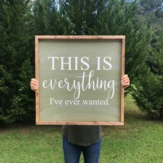 a woman holding up a sign that says, this is everything i've ever wanted