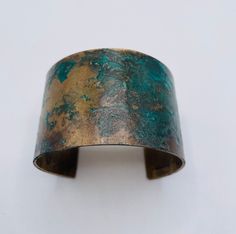 Our wide bronze cuff is hand forged and given a unique textured finish. The piece is then given a rich verdigris patina which ranges in color from black, to deep browns and vibrant greens. The aging process creates a different, organic patina on each piece. No two bracelets are exactly alike. A true one of a kind just like you. This is a great idea for a bronze anniversary gift. Each piece is sealed to protect it's finish. However, to preserve the patina it is best not to wear the piece while sw Bronze Brass Bracelet With Patina, Bronze Brass Bracelets With Patina, Vintage Bronze Cuff Bracelet With Patina, Vintage Brass Cuff Bracelet With Patina, Bronze Patina Cuff Bangle Bracelet, Unique Green Patina Cuff Bracelet, Gold Copper Cuff Bracelet With Patina, Green Patina Cuff Bracelet As Gift, Green Patina Cuff Bracelet Gift