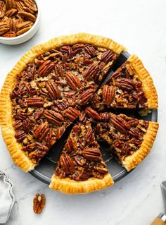 pecan pie on a platter with one slice cut out